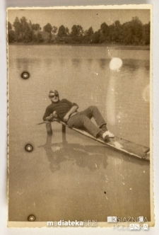 Mężczyzna leżący na wąskim podeście na jeziorze, PGR Kociołek, 1973 r.