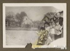 Ludzie pozujący do zdjęcia na tle domów