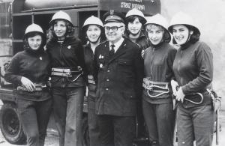 Sześć kobiet i mężczyzna, za nimi samochód z napisem: Ochotnicza Straż Pożarna
