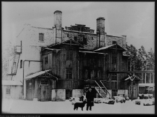 Mężczyzna z psem przed budynkiem browaru